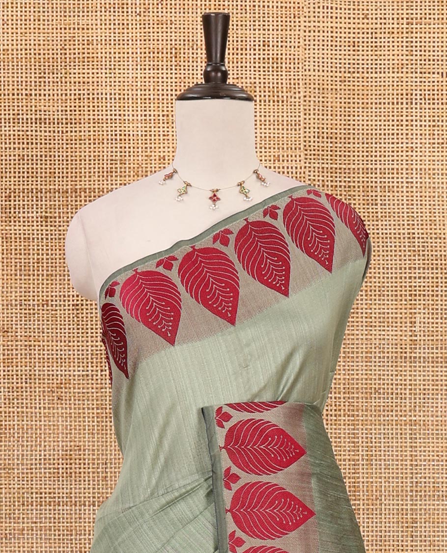 Pista green plain jute cotton saree , contrast leaf thread butta border & lining seer pallu with tussels