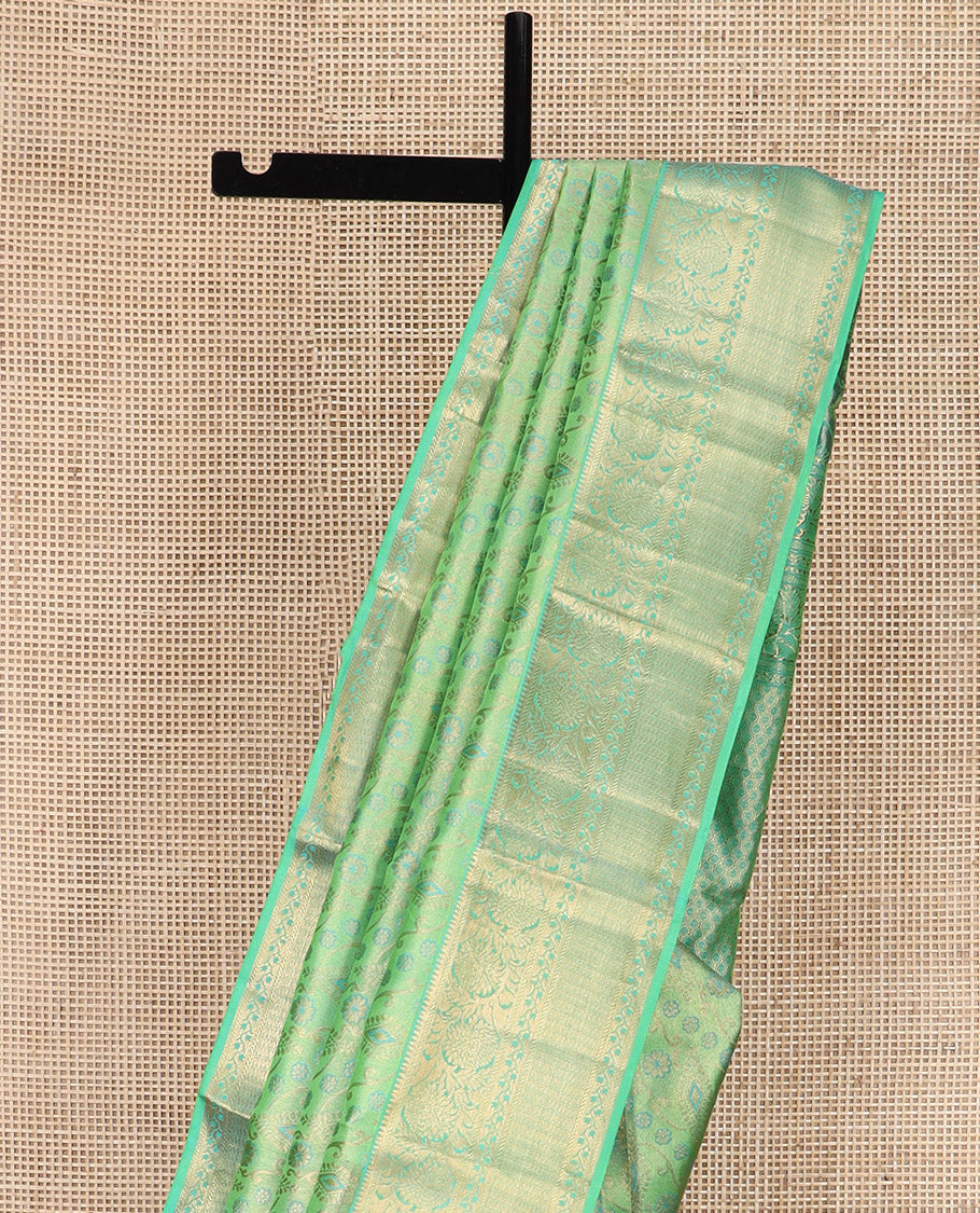 Green Kanchipuram Wedding Silk Saree Beautifully Bedecked with Meenakari Jacquard Designs, Highlighted with Contrast Border of Rekku, Kathir, and Kodi Visiry Designs, Grandly Decked Up Pallu of Jaal Designs, and Paired with a Contrast Blouse