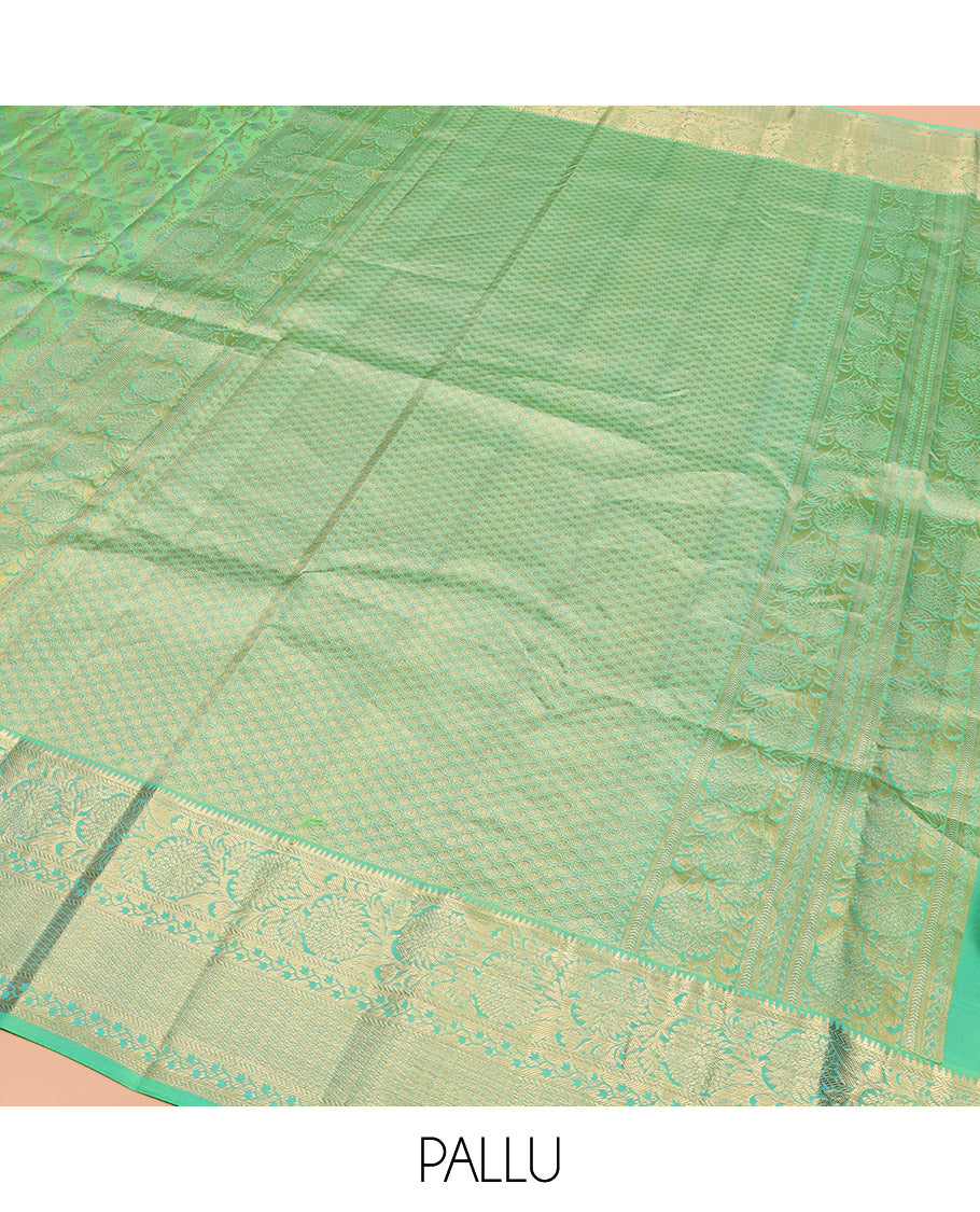 Green Kanchipuram Wedding Silk Saree Beautifully Bedecked with Meenakari Jacquard Designs, Highlighted with Contrast Border of Rekku, Kathir, and Kodi Visiry Designs, Grandly Decked Up Pallu of Jaal Designs, and Paired with a Contrast Blouse