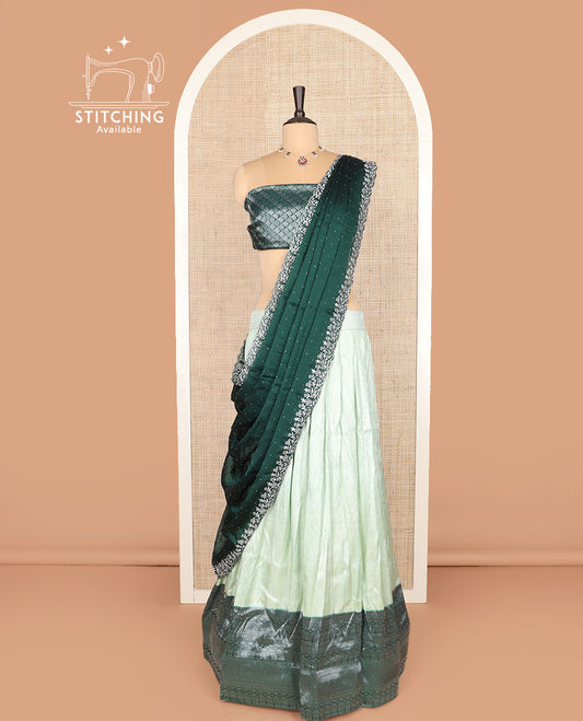 Pale green art silk half-saree, sparsely woven design with contrast traditional zari border skirt, contrast jacquard blouse, and scallop embroidered dhavani