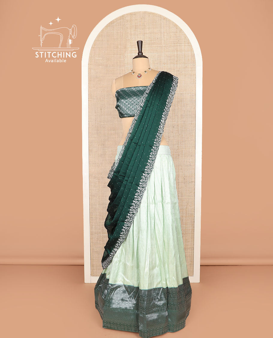 Pale green art silk half-saree, sparsely woven design with contrast traditional zari border skirt, contrast jacquard blouse, and scallop embroidered dhavani