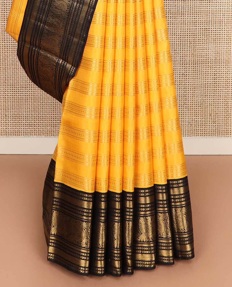 Yellow zari striped Kanchipuram silksaree, contrast border of kathir, and mayil designs, and pallu of mayil kann designs