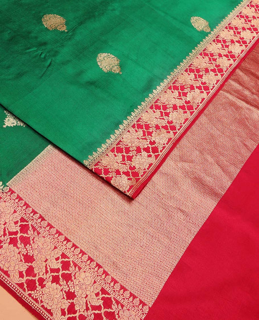 Green Raw Mango Silk Saree Ornamented with Buttas, Complemented by a Contrast Traditional Zari-Design Border, Pallu Depicts Peacock Eye Design, and Paired with a Contrast Blouse