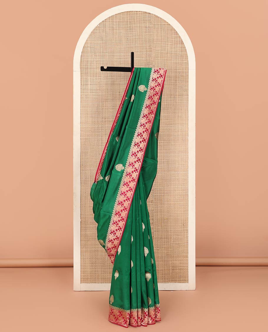 Green Raw Mango Silk Saree Ornamented with Buttas, Complemented by a Contrast Traditional Zari-Design Border, Pallu Depicts Peacock Eye Design, and Paired with a Contrast Blouse
