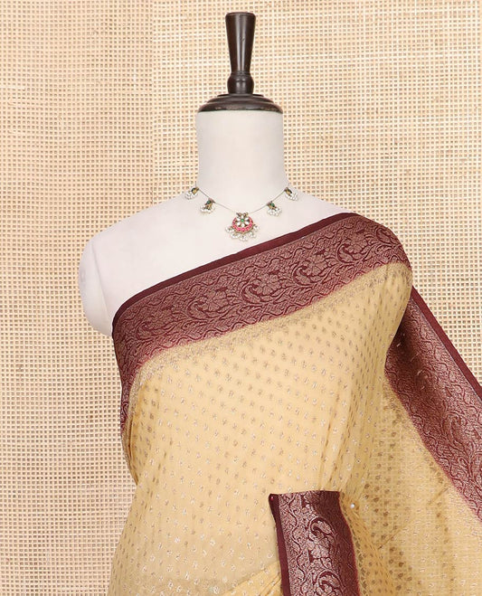 Sandal Fancy Georgette Saree Detailed with Zari Buttas, Complemented by a Contrast Border of Floral Creeper Designs, Grandly Woven Pallu Featuring Floral Jaal Designs in Zari, and Paired with a Contrast Blouse
