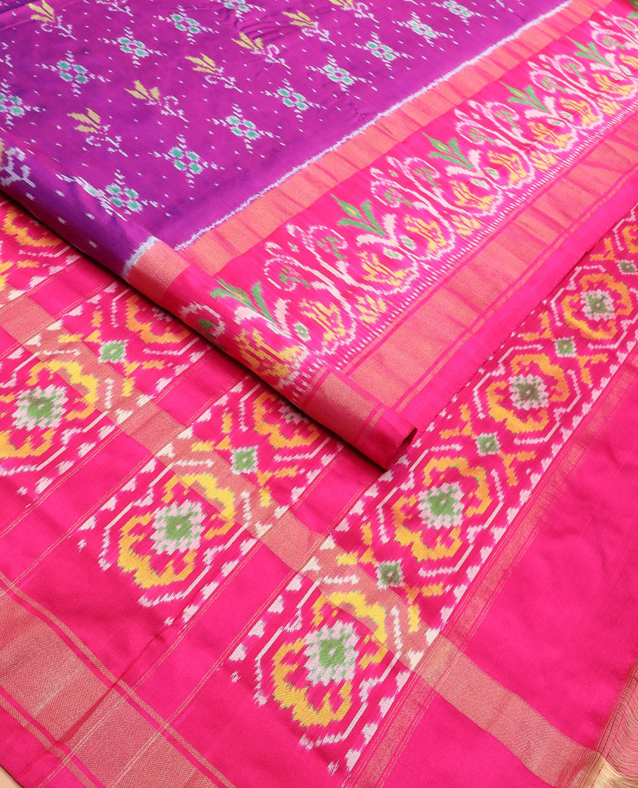 Rani Pink Ikkat Silk Saree Adorned with Colourful Buttas, Complemented by an Ikkat Woven Border, a Colourfully Woven Ikkat Pallu, and a Contrast Blouse