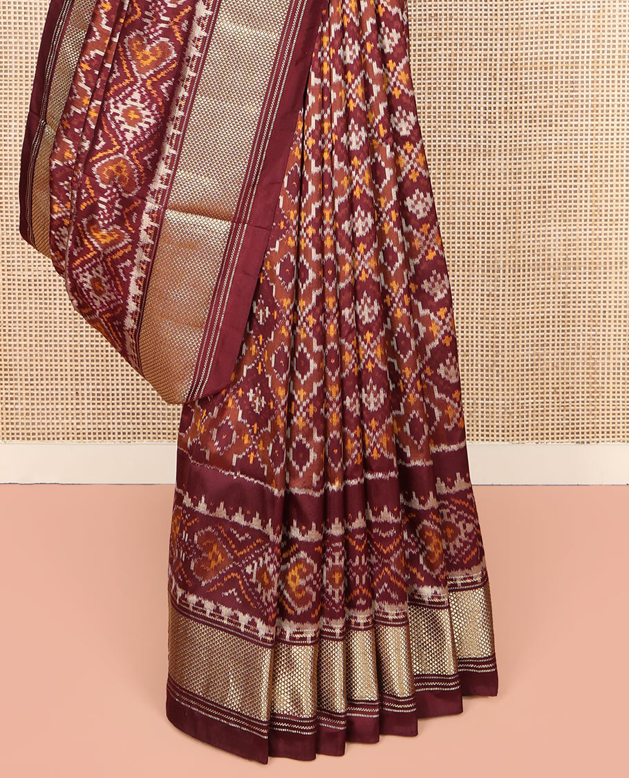 Brown Ikkat Silk Saree, Elevated with Ikkat Checks All Over Its Body, Subtle Border of Jaal Designs, Pallu of Geometric Designs, and Paired with a Matching Blouse