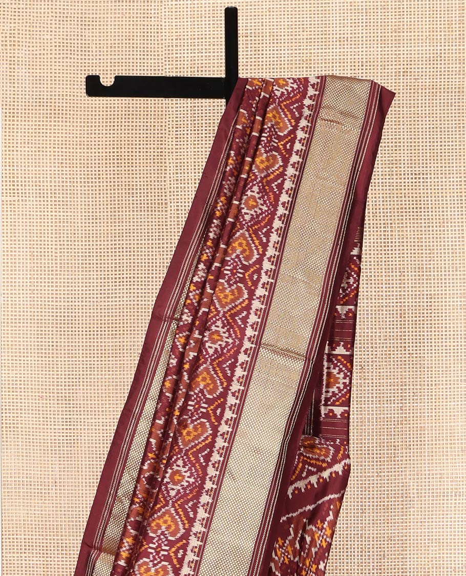 Brown Ikkat Silk Saree, Elevated with Ikkat Checks All Over Its Body, Subtle Border of Jaal Designs, Pallu of Geometric Designs, and Paired with a Matching Blouse