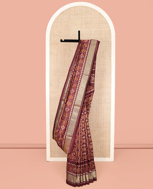 Brown Ikkat Silk Saree, Elevated with Ikkat Checks All Over Its Body, Subtle Border of Jaal Designs, Pallu of Geometric Designs, and Paired with a Matching Blouse