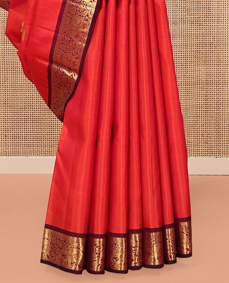 Orange Kanchipuram Silk Saree, Mesmerized with Mayil and Chakram Buttas All Over Its Body, Complemented by Contrast Border of Thilakam, Cross Kamalam, and Yaanai Designs, Pallu Steeped with Rettai Mayil Designs, and Paired with a Contrast Blouse