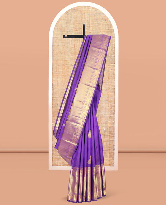 Violet Kanchipuram Silk Saree, Opulently Embellished with Jhumka Zari Buttas, Highlighted by a Zari Border of Arumbu Manga, Mayil, and Paiyadi Kann, Grand Pallu, and Matching Blouse