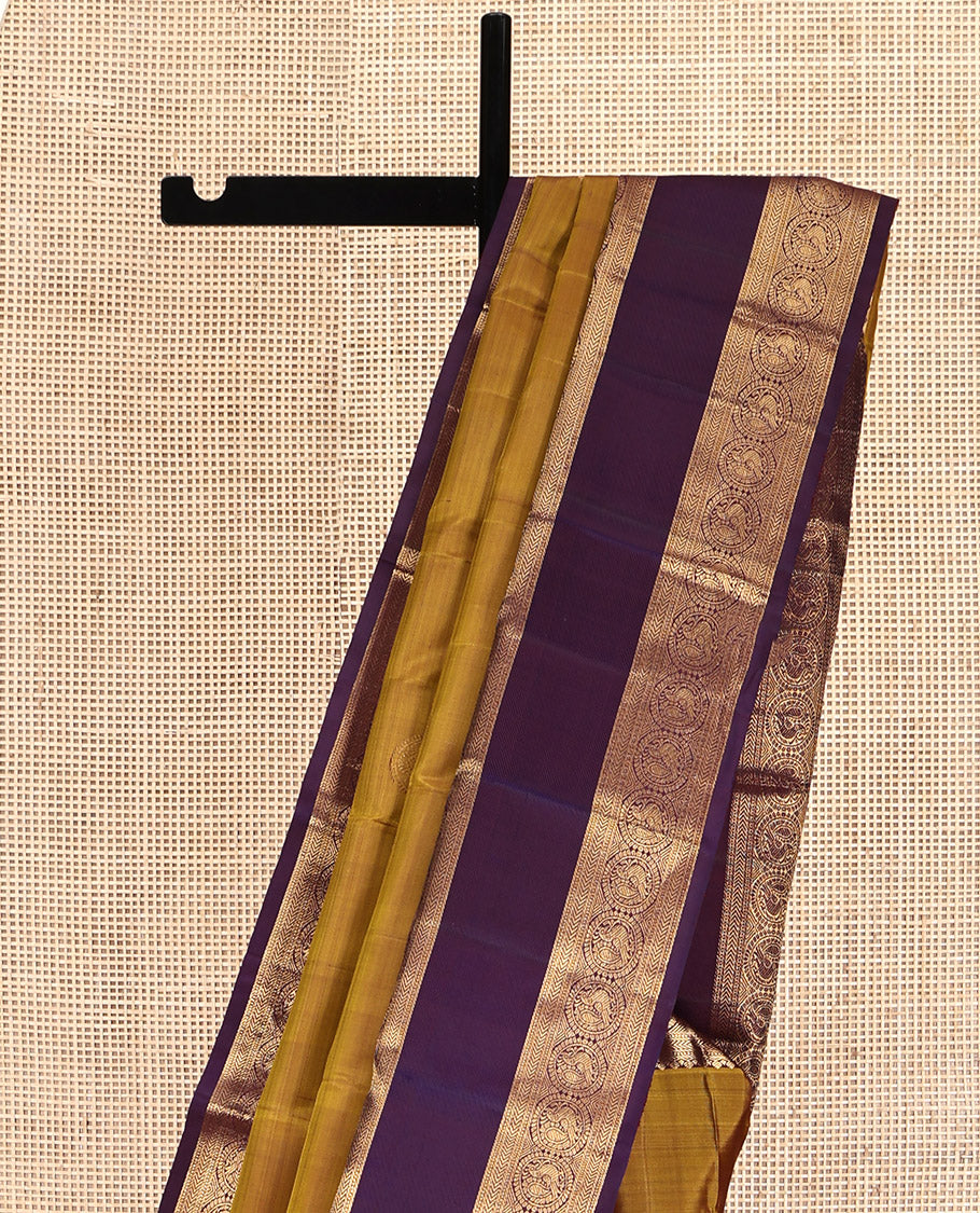 Mustard Kanchipuram Silk Saree, Embellished with Round Buttas All Over Its Body, Complemented by a Contrast Rettai Pettu Border of Thilakam Mokku, Muthu, Kathir, and Round Mayil Designs, Grand Jaal Pallu, and Paired with a Contrast Blouse