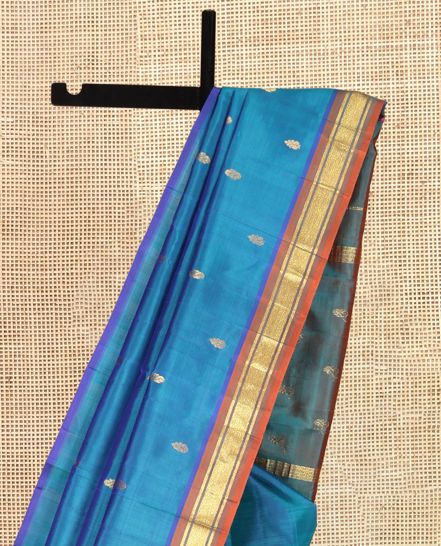 Blue Kanchipuram Silk Saree, Elevated with Zari Buttas, Complemented by a Contrast One-Sided Border of Banaras, and Mayil Kann Designs, Zari Woven Pallu, and a No Blouse