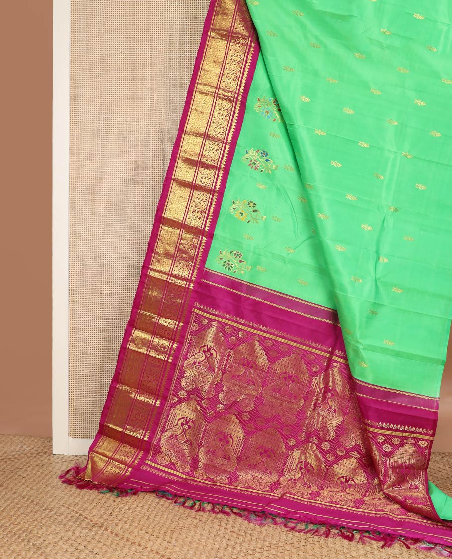 Green floral meena buttas Kanchipuram silksaree, contrast one-sided korvai border of thilakam mokku, manga & jaal & peacock inside palanquin design pallu