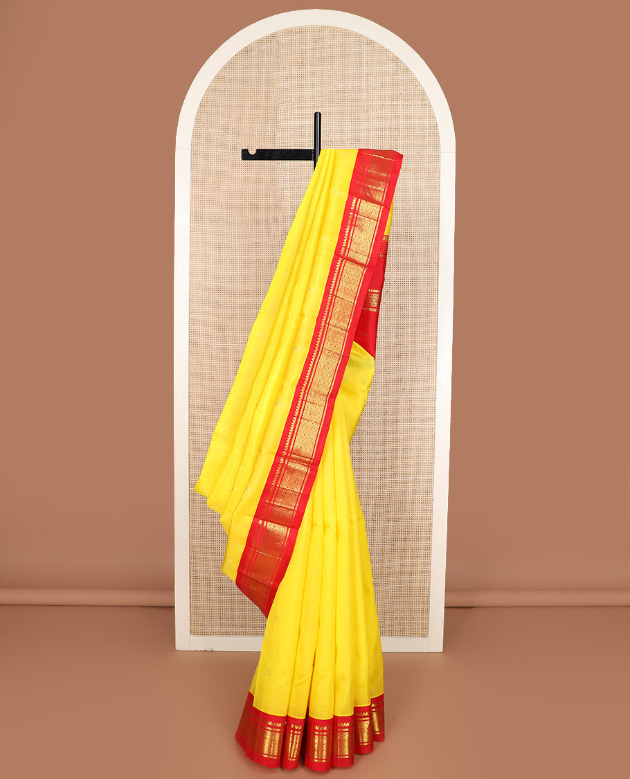 Yellow zari buttas Kanchipuram silk saree, contrast one-sided korvai border of salangai, banaras, and jaal design, and zari design pallu