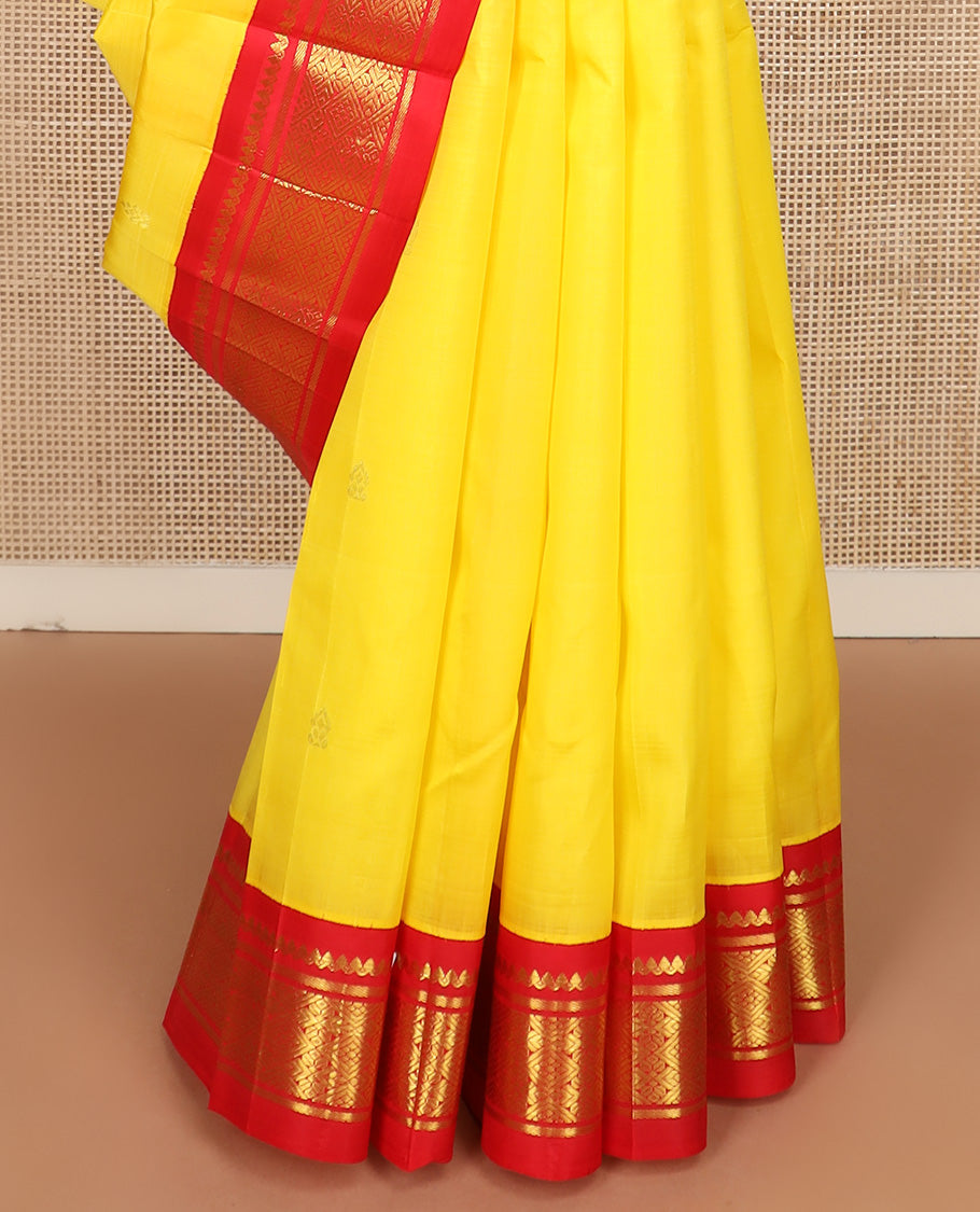 Yellow zari buttas Kanchipuram silk saree, contrast one-sided korvai border of salangai, banaras, and jaal design, and zari design pallu