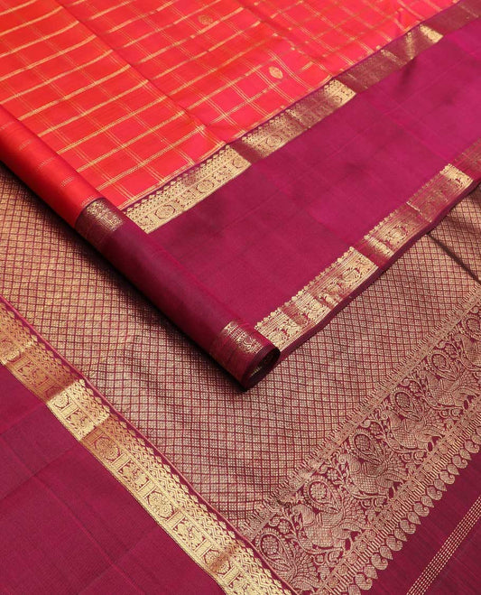 Red checked with zari buttas Kanchipuram silk saree, contrast rettai pettu border of thilakam, muthu, annam chakram designs, and jaal pallu