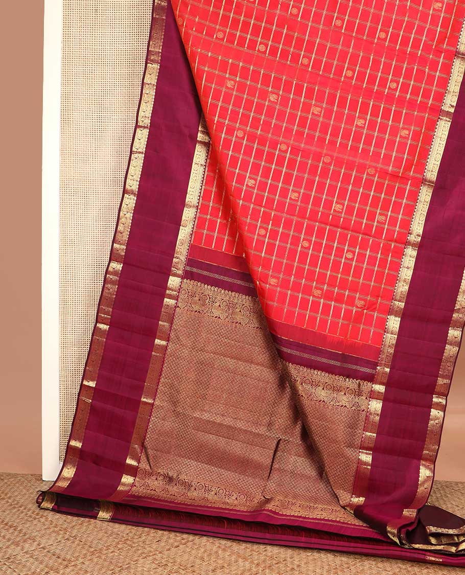 Red checked with zari buttas Kanchipuram silk saree, contrast rettai pettu border of thilakam, muthu, annam chakram designs, and jaal pallu