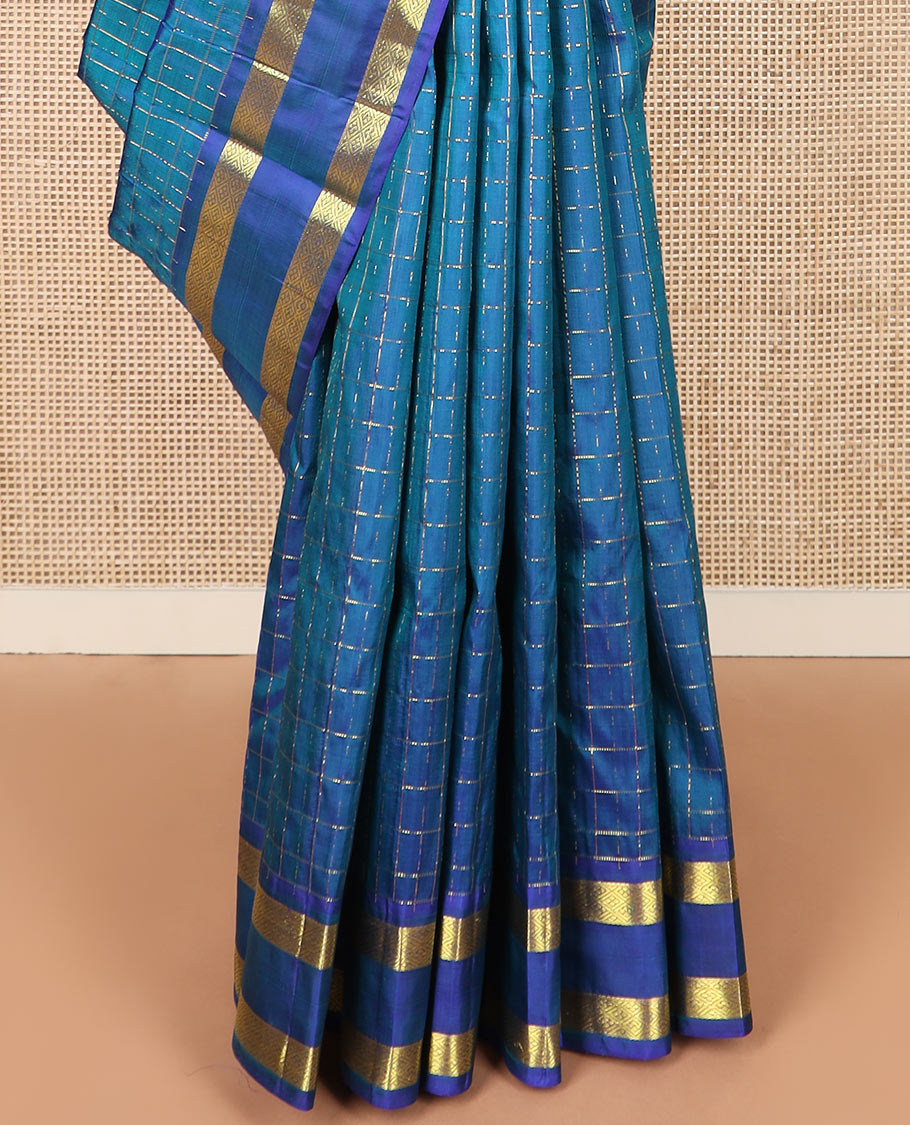 Blue zari checked Kanchipuram silk saree, rettai pettu diamond patterned border, and pallu of annam, kamalam, and manga designs