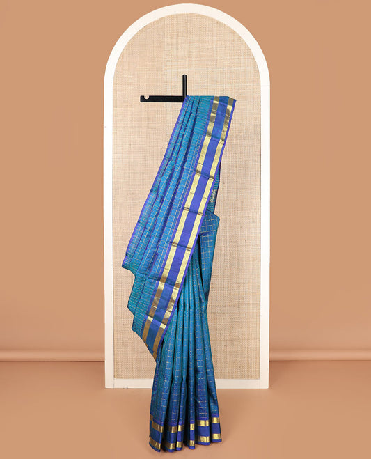 Blue zari checked Kanchipuram silk saree, rettai pettu diamond patterned border, and pallu of annam, kamalam, and manga designs
