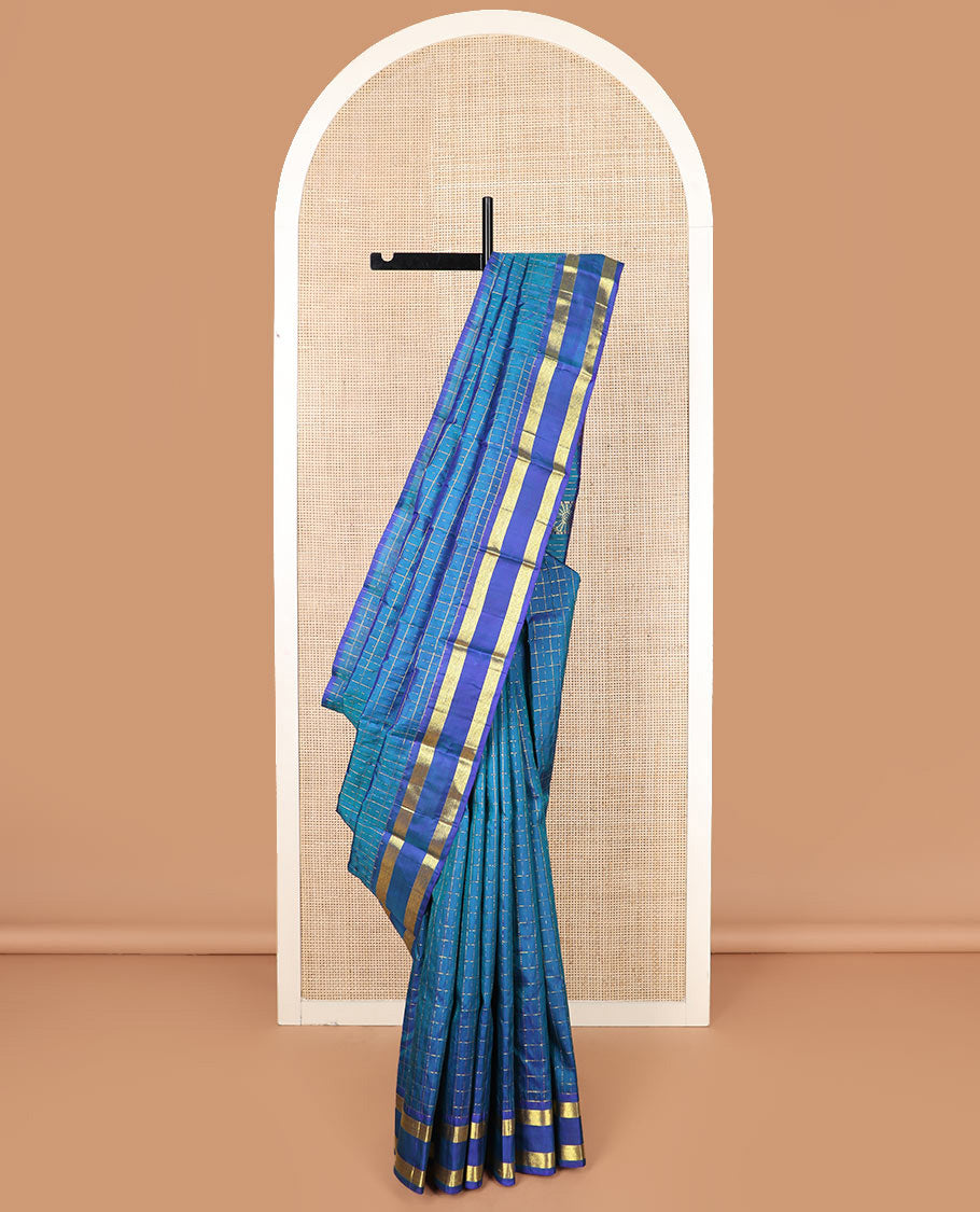 Blue zari checked Kanchipuram silk saree, rettai pettu diamond patterned border, and pallu of annam, kamalam, and manga designs