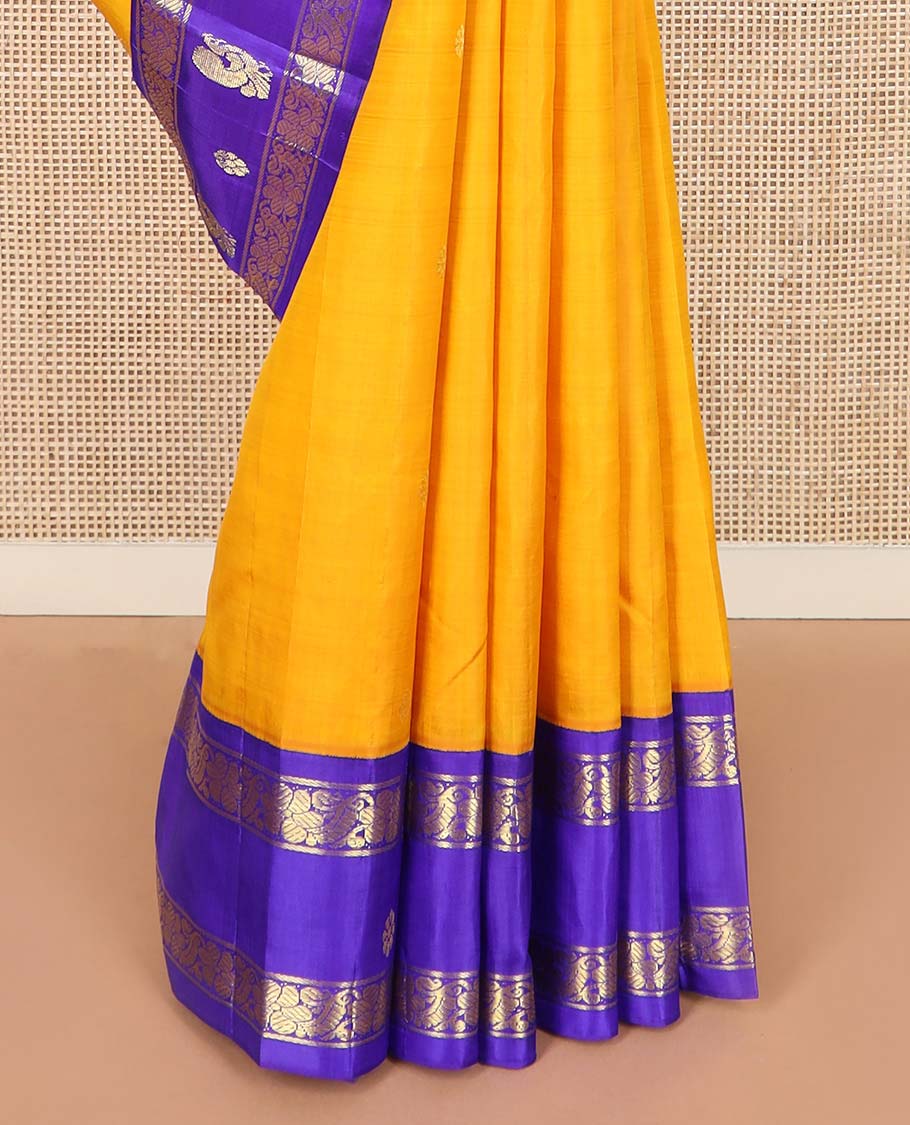 Yellow zari buttas Kanchipuram silk saree, contrast korvai one-sided border of mayil, kamalam, and kodi visiry designs, and pallu of intricate designs
