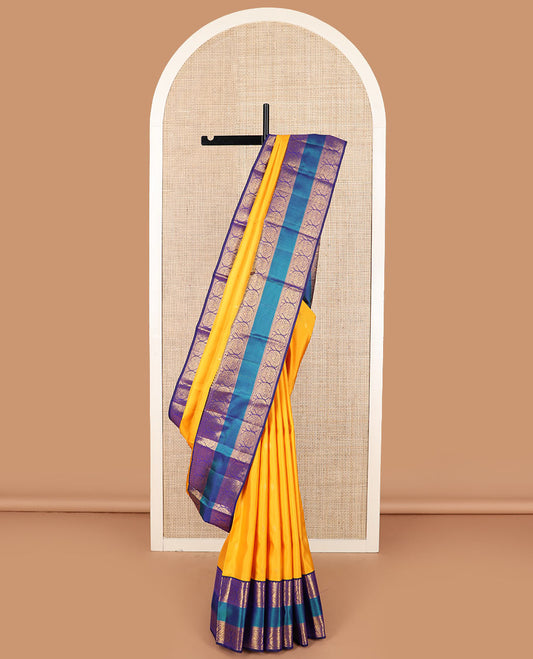 Yellow zari buttas Kanchipuram silk saree, contrast border of salangai, manga, muthu, arumbu manga, and mayil kann designs, and vanki pallu