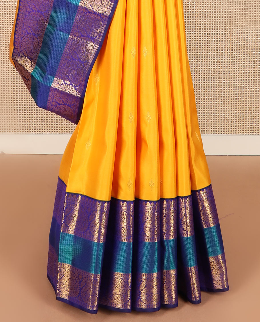 Yellow zari buttas Kanchipuram silk saree, contrast border of salangai, manga, muthu, arumbu manga, and mayil kann designs, and vanki pallu