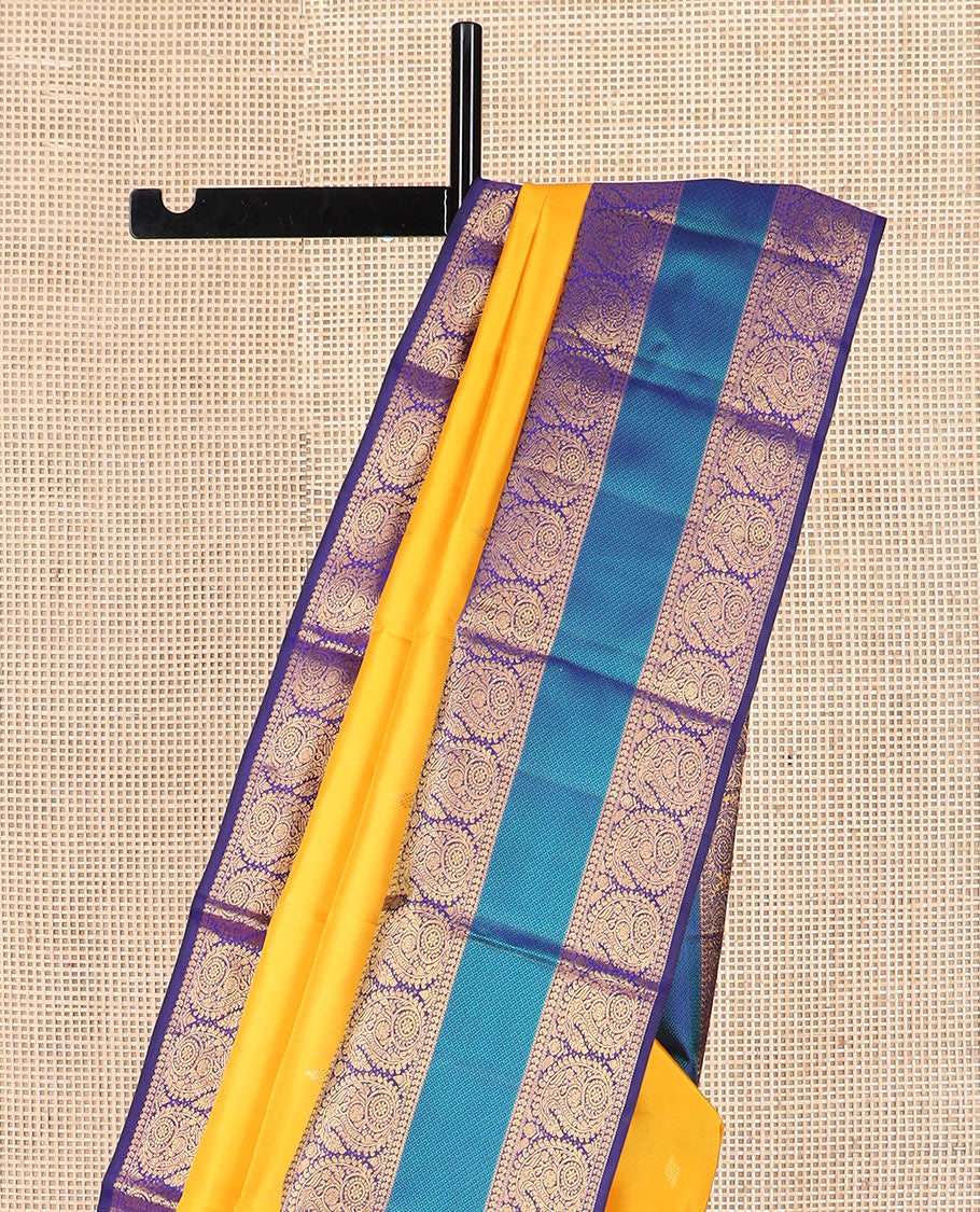 Yellow zari buttas Kanchipuram silk saree, contrast border of salangai, manga, muthu, arumbu manga, and mayil kann designs, and vanki pallu