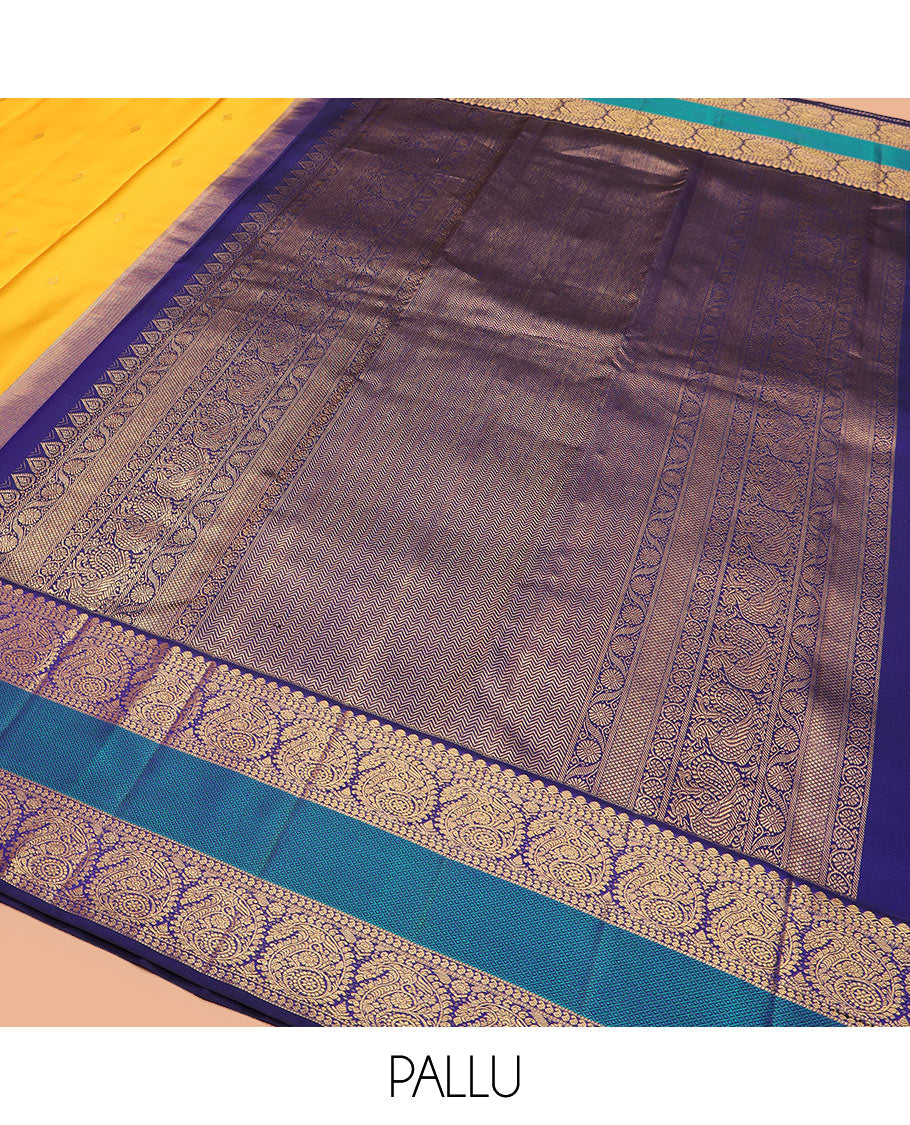 Yellow zari buttas Kanchipuram silk saree, contrast border of salangai, manga, muthu, arumbu manga, and mayil kann designs, and vanki pallu