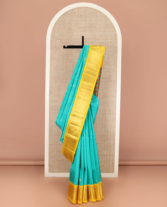Turquoise Kanchipuram Silk Saree Prettified with Zari Buttas All Over Its Body, Complemented by Contrast One-Sided Korvai Border of Manga Mokku, and Vanki Designs, Pallu Steeped with Floral-Paisley Designs, and Comes Without a Blouse