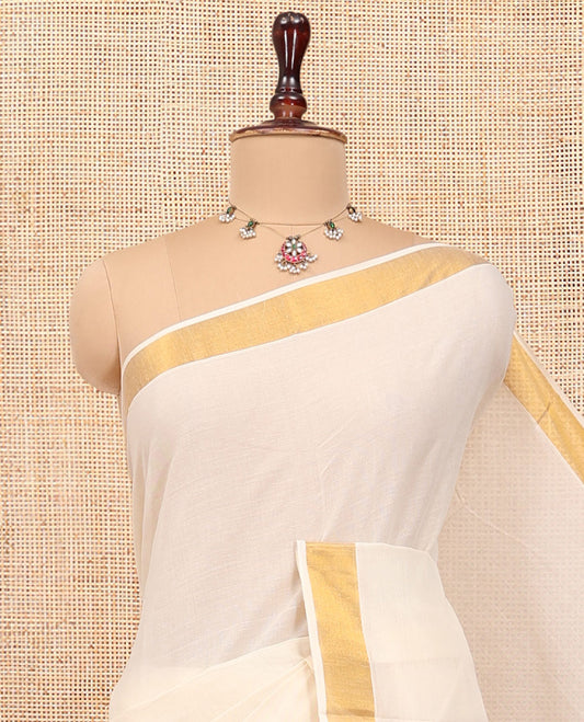 Cream Kerala Cotton Saree, Steeped with Zari Buttas All Over Its Body, a Subtle Bavanji Border, Pallu Features Stripes and Buttas, and Is Paired with a Matching Blouse