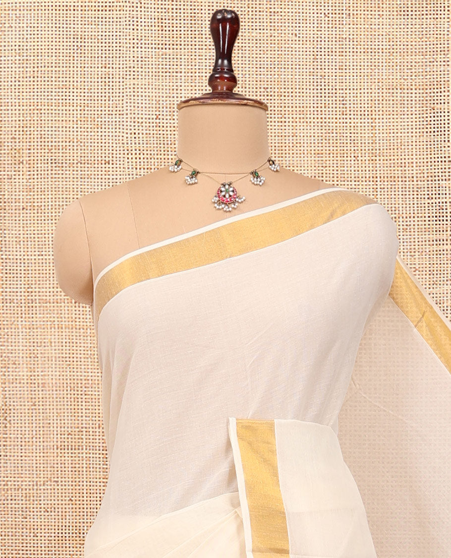 Cream Kerala Cotton Saree, Steeped with Zari Buttas All Over Its Body, a Subtle Bavanji Border, Pallu Features Stripes and Buttas, and Is Paired with a Matching Blouse