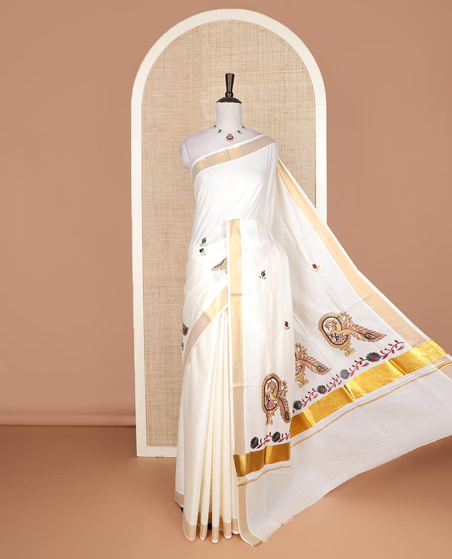 Cream floral motifs embroidered Kerala cotton saree, bavanji border, and peacock embroidered pallu