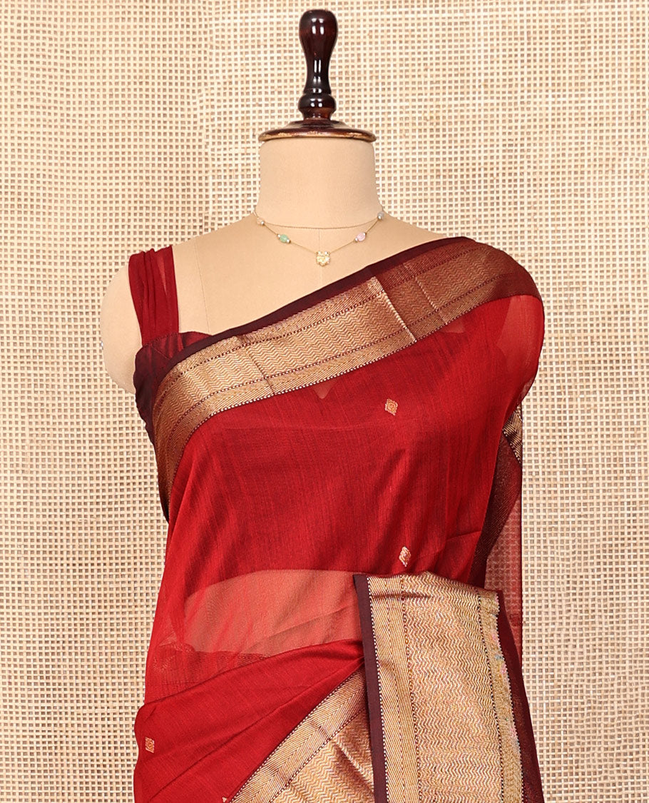 Red Maheshwari Cotton Saree, Accentuated with Buttas All Over Its Body, Complemented by a Contrast Traditional Zari Woven Border of Chevron Designs, Pallu Mirrors the Same Design, and Paired with a Matching Blouse