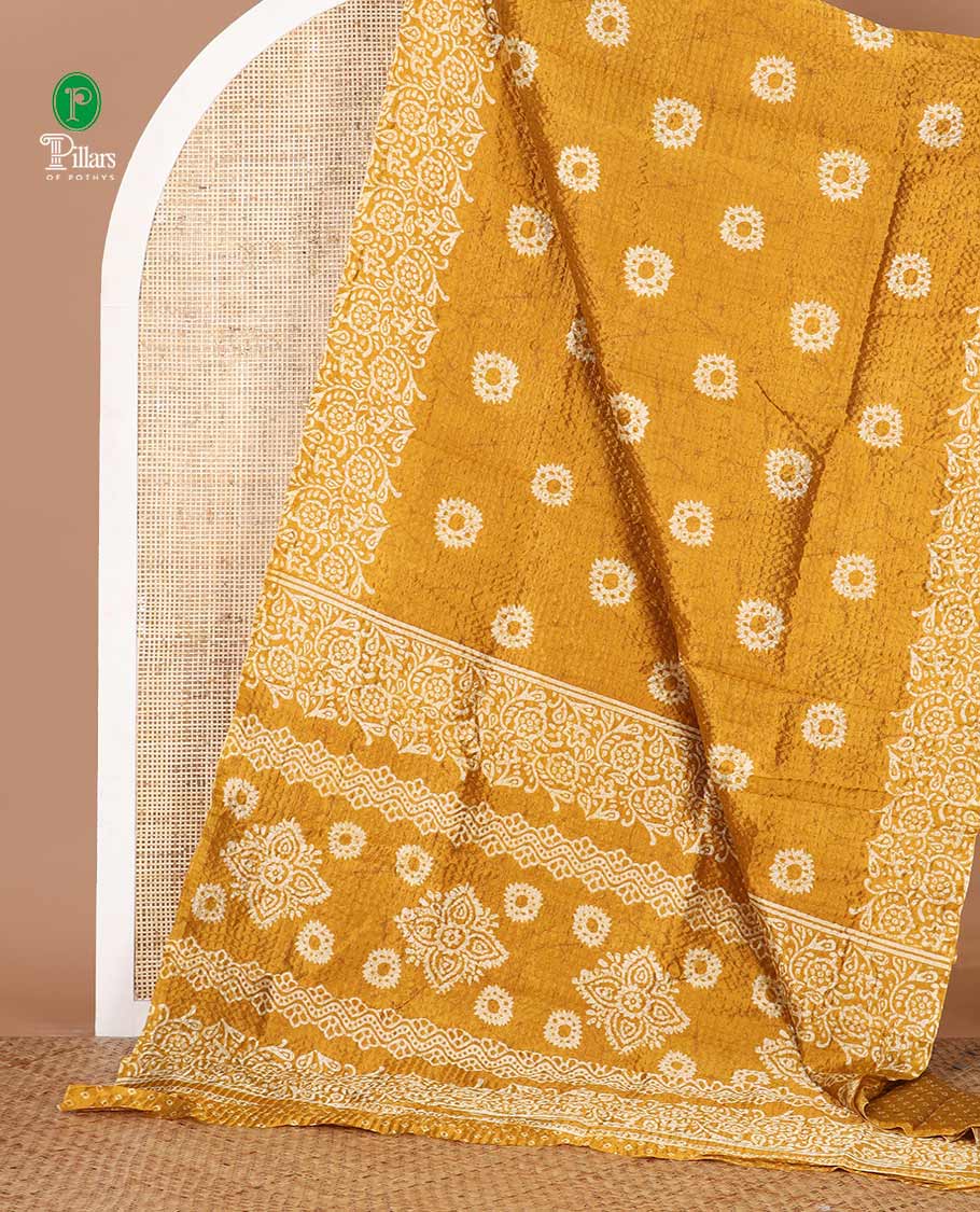 Mustard batik-floral buttas printed litchi crushed saree, batik-floral printed border, printed pallu & butta print blouse