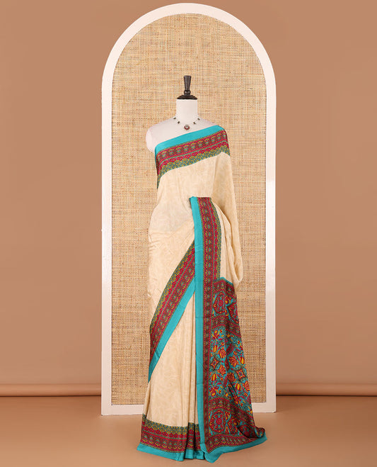Cream leaf motifs printed crepe silk saree, contrast blue printed blouse, kaleidoscope coloured intricately printed border & pallu
