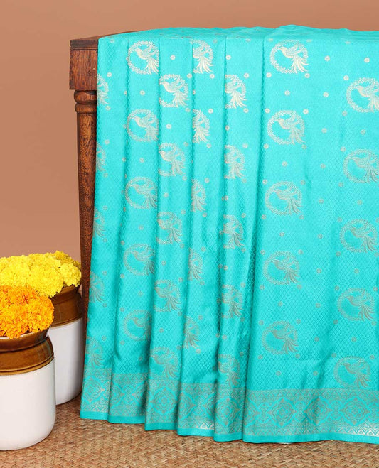 Emerald blue allover embosed with gold zari figure design , zari weaving rich pallu with tussels  & self small butta blouse