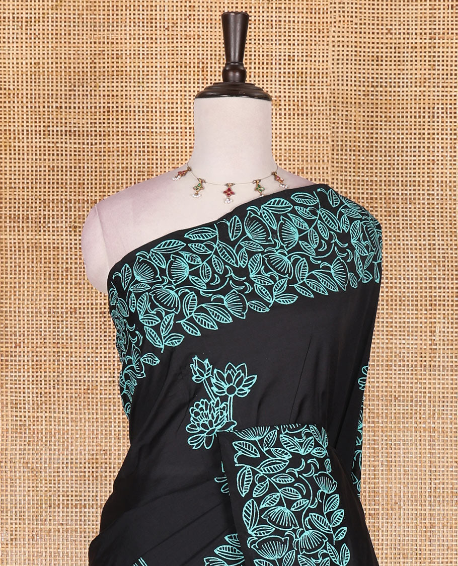 Black floral motifs hand block printed South cotton saree, floral hand block printed border and pallu, along with a contrast printed blouse