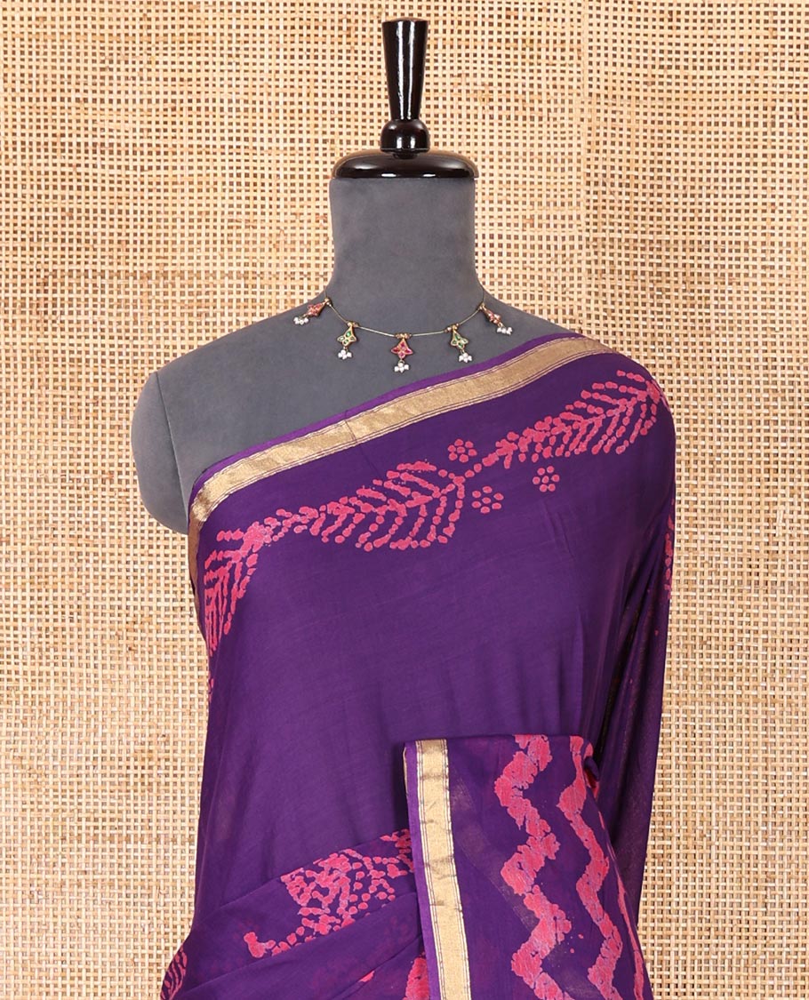 Violet wax batik-style zig-zag printed pure cotton saree, gold zari piping border, human figurines batik printed pallu, and a matching blouse