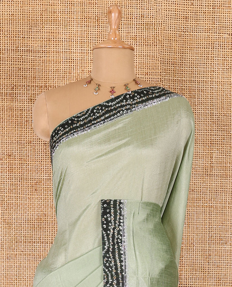 Pista green plain Vichitra silk saree, contrast bandhani printed with Swarovski micro-stonework border, and a contrast bandhani printed blouse