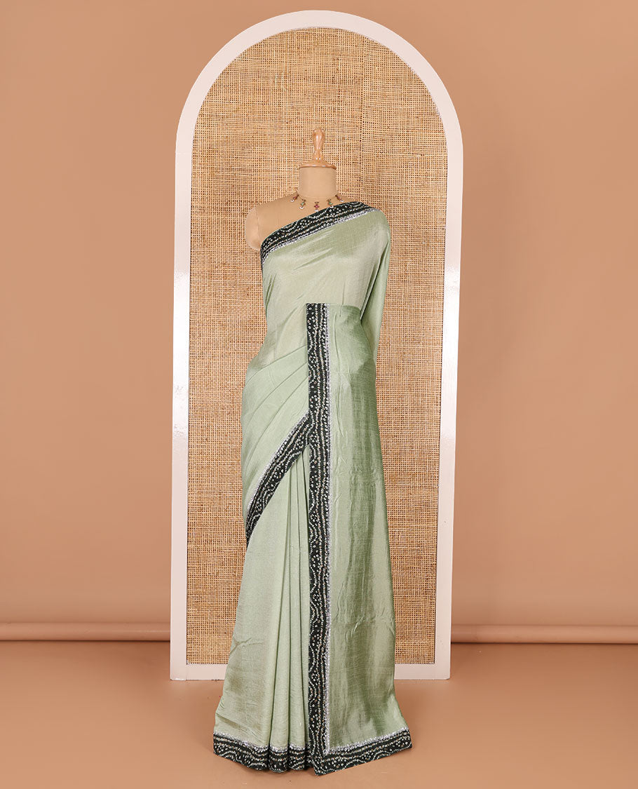 Pista green plain Vichitra silk saree, contrast bandhani printed with Swarovski micro-stonework border, and a contrast bandhani printed blouse