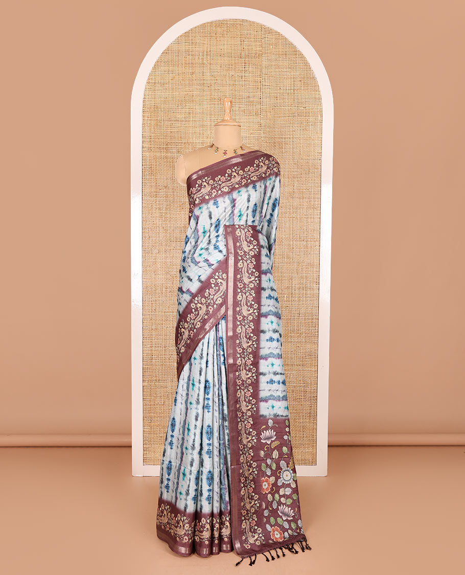 Blue shibori printed katan silk saree, contrast border, and pallu of kalamkari floral vine and peacock print, and a contrast leaf printed blouse