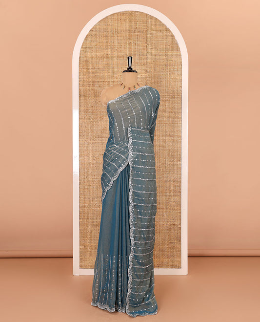 Blue vertical stripes embroidered shimmer chiffon saree, scallop embroidered border, embroidered pallu, and fancy embroidered matching blouse