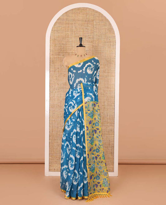 Borderless blue shibori printed linen cotton saree, contrast kaleidoscope colored kalamkari floral vine print, and a contrast printed blouse