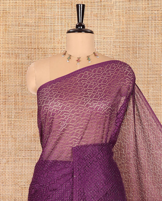 Borderless green sparkling glitter russel net saree with self-pallu, and a contrast floral printed and zig-zag patterned blouse