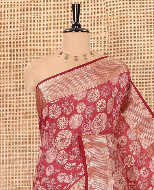 Maroon lotus-leaf style printed semi-tussar saree, traditional zari border, zari striped pallu, and a matching blouse