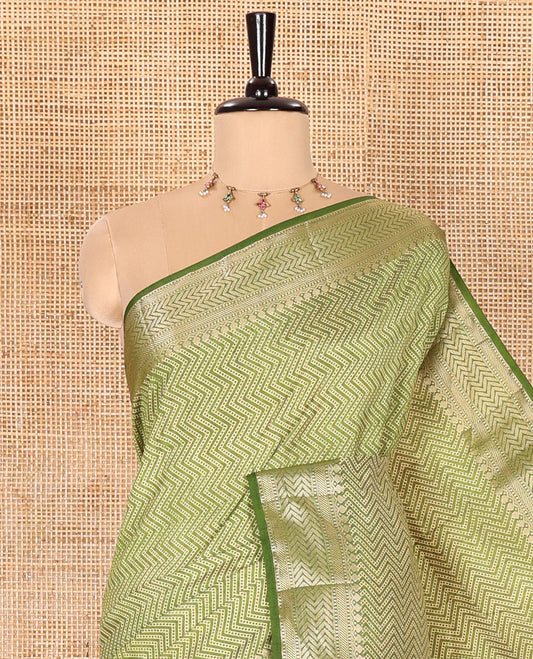 Green Semi-Tussar Saree Accentuated with Zig-Zag Strips Prints, Featuring a Self-border with Traditional Motifs, a Zari-Striped Pallu, Paired with a Matching Blouse