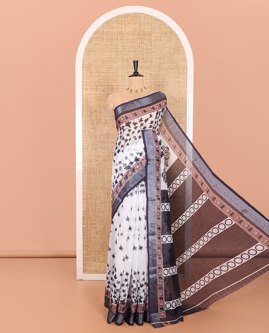 White and Black Linen Cotton Saree Featuring Field Maple Leaf Motifs Printed All Over the Body, Complemented by a Contrast Zari and Peacock-Printed Border, Pallu of Geometric Print, and Paired with a Contrast Checked Blouse