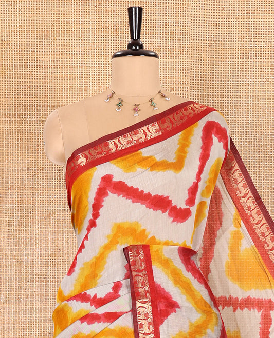 Yellow Muslin Cotton Saree Embellished with Zig-Zag Shibori Patterns Prints, Complemented by a Contrast Border of Deer Motifs in Zari, Pallu Decked Up with Scenery Print, and Paired with a Contrast Polka Dots Printed Blouse